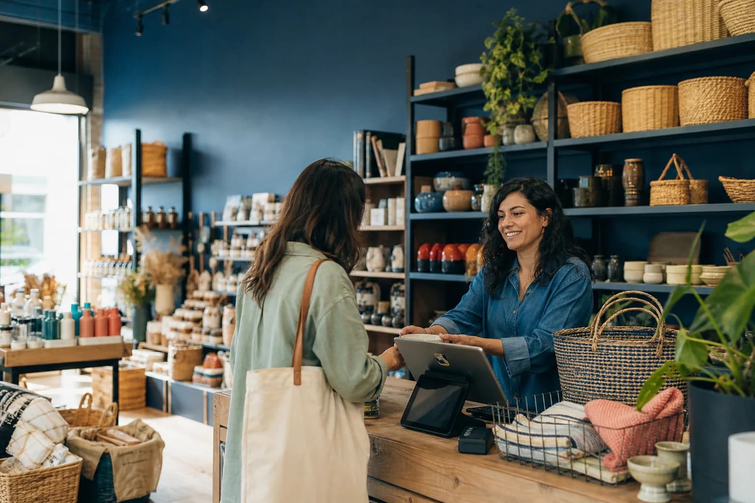 Shop owner using a point-of-sale system in a multiproduct store